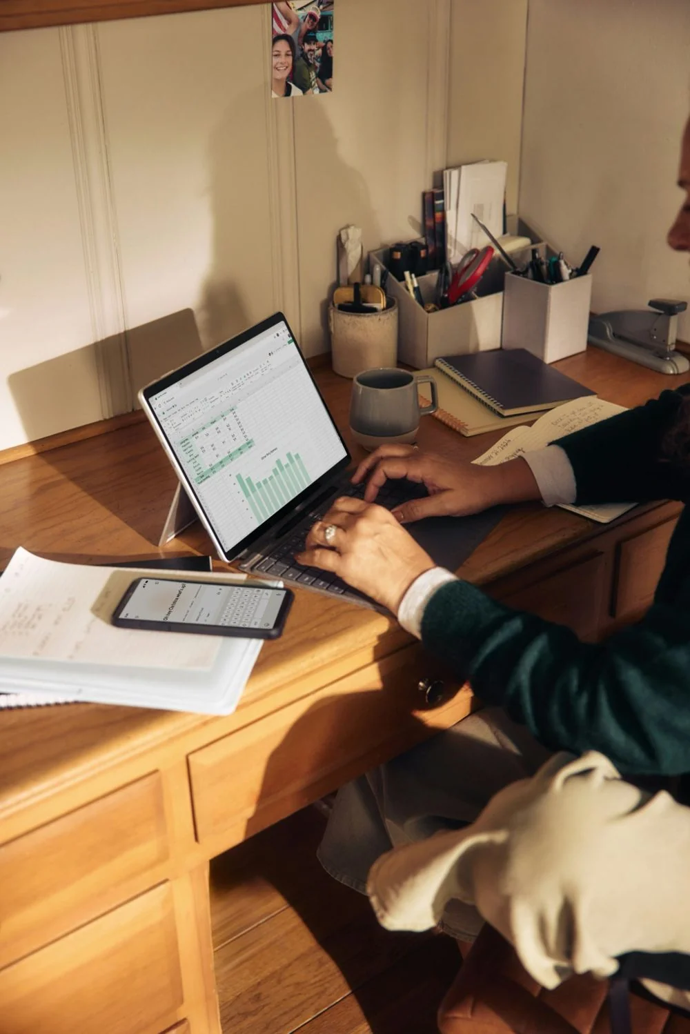 Global Marketing & Communications Leader 1 A team member working through prospect data in a spreadsheet at a wooden desk
